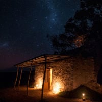 The old Shephers Hut in the Yorke Peninsula glows late at night as the stars shine overhead 
